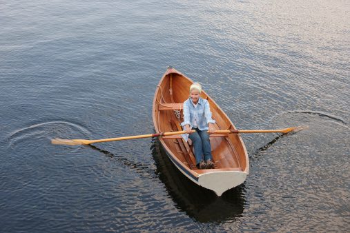Happy mature woman rowing